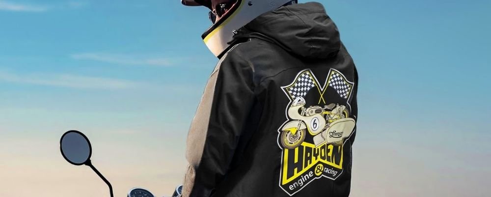 Black jacket printed with a Hayden racing motorcycle design and chequered flags