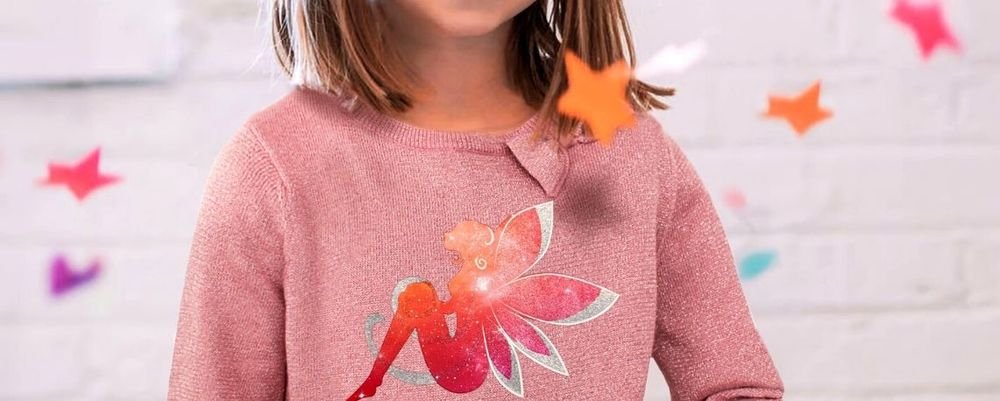Child wearing a pink sweater decorated with a sparkly fairy transfer